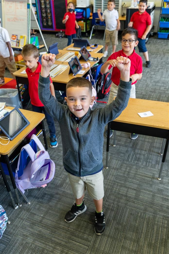 Boy raising hands