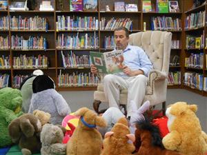 Mr. Blunt reading to stuffed animals 