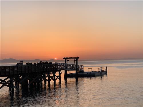 Students on the pier at sunset.