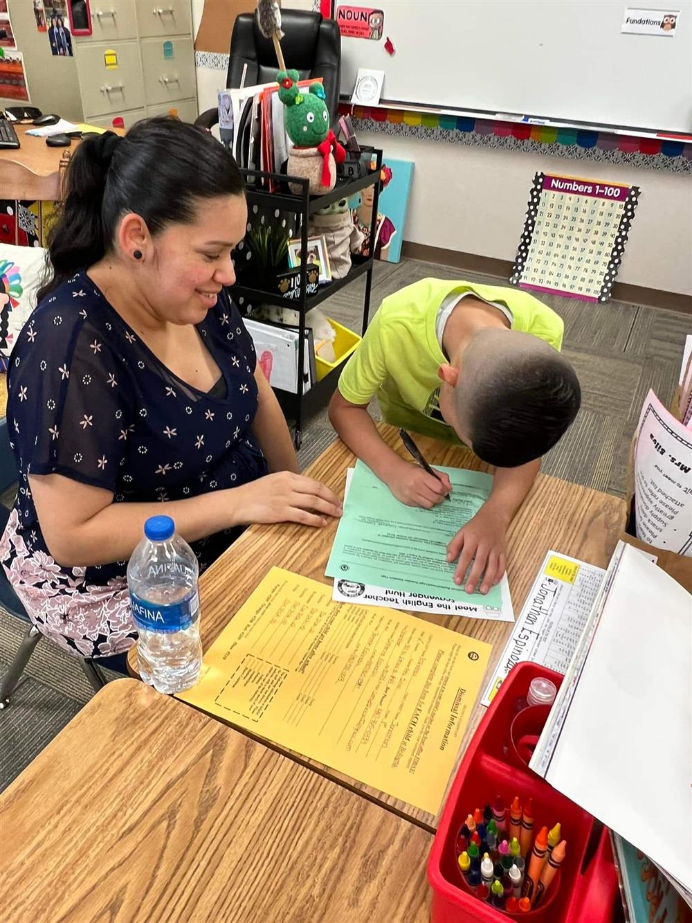 Mother and son filling out paperwork