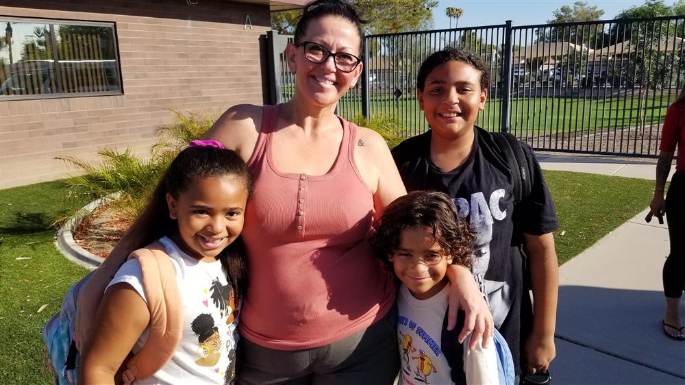 A guardian drops off students at Sanborn Elementary School