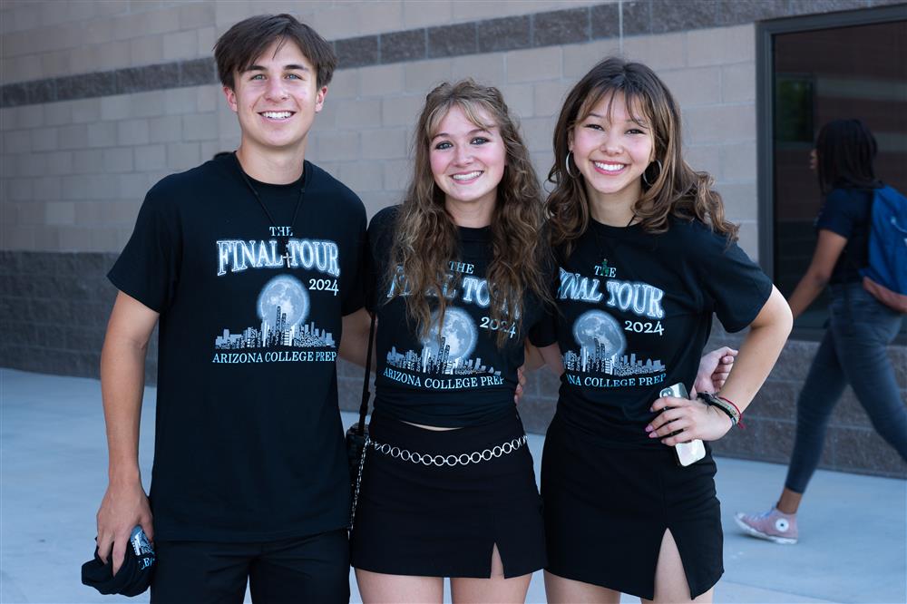 Three students smile for the camera at Arizona College Prep High