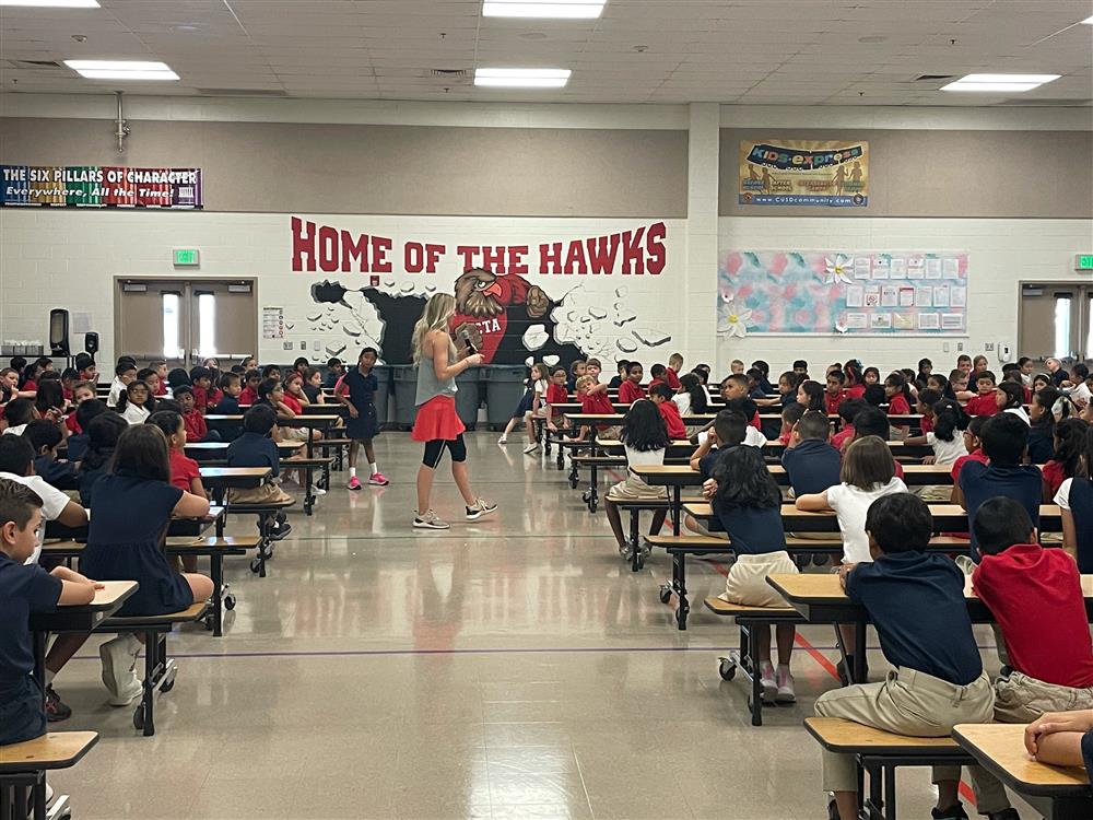 A wide shot photo of Independence's multipurpose room with students