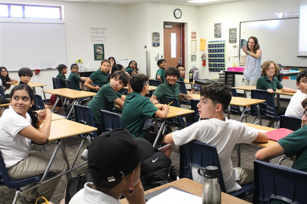 Students turn around after their teacher points to the back of the class at Basha AMS