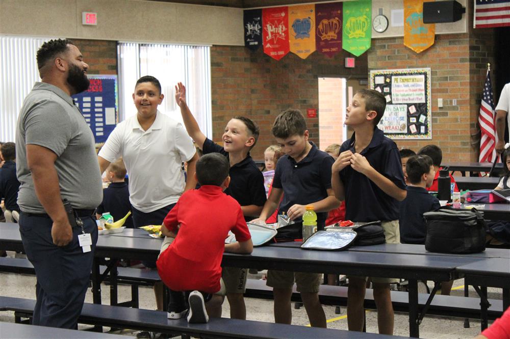 Students greet an administrator at Chandler Traditional Academy