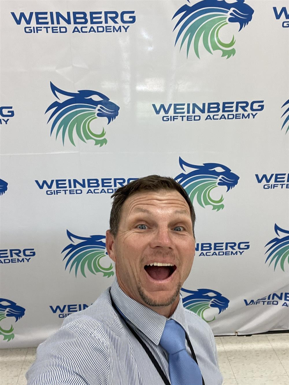 A teacher from Weinberg Gifted Academy smiles for the camera