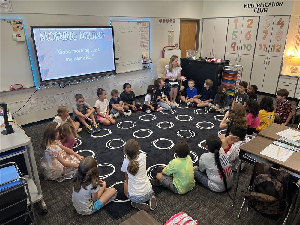 A class sits on a rug at Jacobson Elementary School