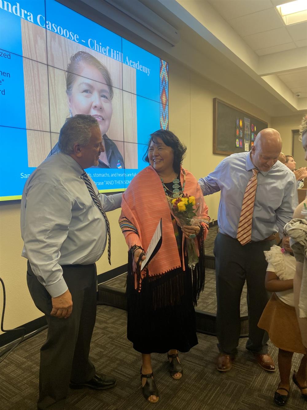 Mrs. Casoose receiving her award